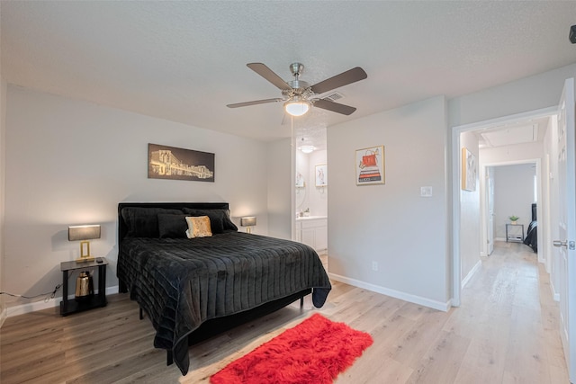 5825 Village Forest Ct, Houston, TX 77092 - bedroom featuring attic access, light wood finished floors, baseboards, a ceiling fan, and a textured ceiling