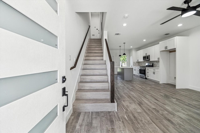 990-992 Marjorie St, Houston, TX 77088 - staircase featuring a ceiling fan, recessed lighting, and wood finished floors