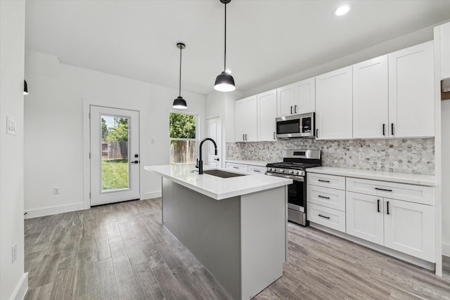 990-992 Marjorie St, Houston, TX 77088 - kitchen with appliances with stainless steel finishes, a sink, backsplash, light wood finished floors, and recessed lighting