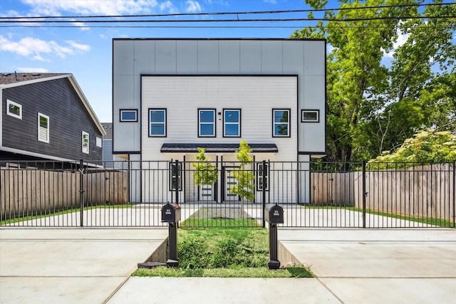 990-992 Marjorie St, Houston, TX 77088 - contemporary home with concrete driveway, a fenced front yard, and a gate