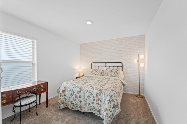 bedroom featuring brick wall, carpet, and baseboards