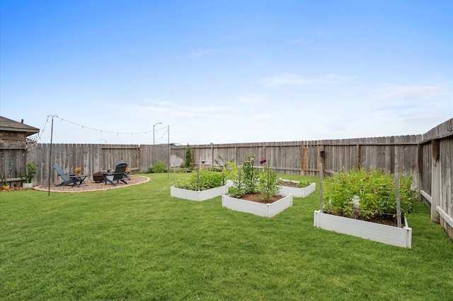 view of yard with a garden and a fire pit