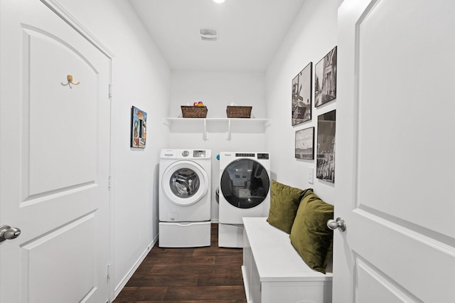 washroom with washer and dryer, dark wood-style flooring, and baseboards