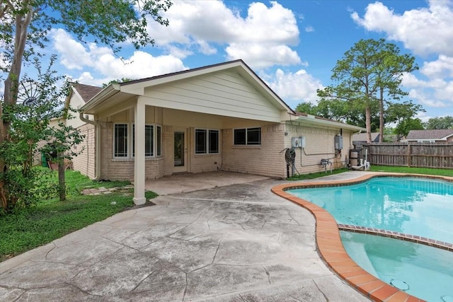 10203 Huntington Dale Dr, Houston, TX 77099 - rear view of house with concrete driveway, brick siding, an attached carport, and a patio area