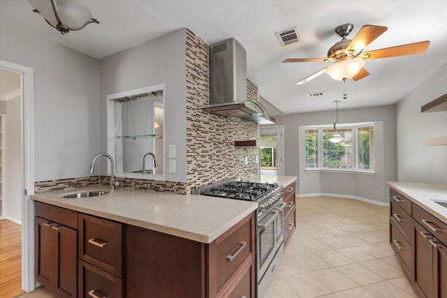 10203 Huntington Dale Dr, Houston, TX 77099 - kitchen featuring stainless steel stove, a sink, wall chimney exhaust hood, and backsplash
