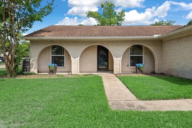 10203 Huntington Dale Dr, Houston, TX 77099 - view of front of home featuring brick siding, a front lawn, roof with shingles, and covered porch
