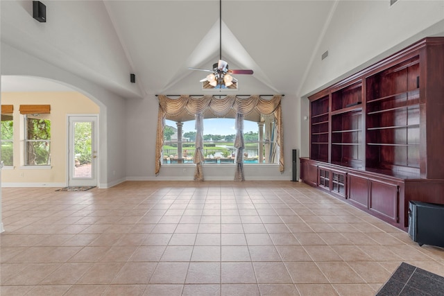 6318 Goodlowe Park, Sugar Land, TX 77479 - unfurnished living room with light tile patterned floors, baseboards, ceiling fan, arched walkways, and vaulted ceiling