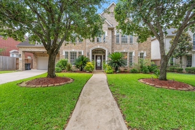 6318 Goodlowe Park, Sugar Land, TX 77479 - view of front of house featuring driveway, brick siding, and a garage