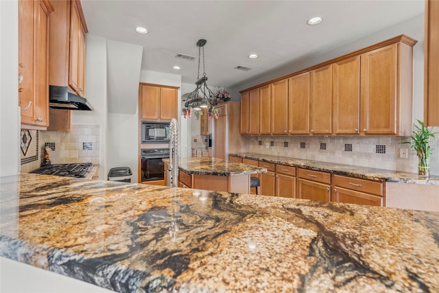 6318 Goodlowe Park, Sugar Land, TX 77479 - kitchen featuring black appliances, under cabinet range hood, light stone countertops, tasteful backsplash, and recessed lighting