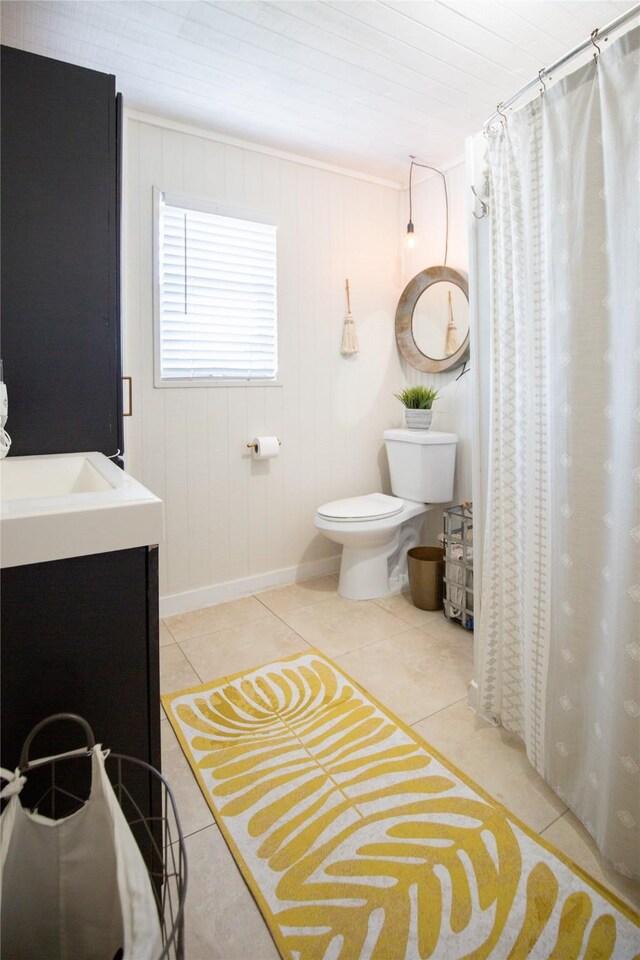 16535 Jamaica Inn Rd, Jamaica Beach, TX 77554 - full bath featuring tile patterned flooring, baseboards, toilet, vanity, and a shower with shower curtain