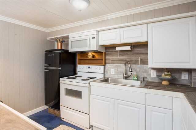 16535 Jamaica Inn Rd, Jamaica Beach, TX 77554 - kitchen featuring white appliances, a sink, decorative backsplash, ornamental molding, and white cabinetry