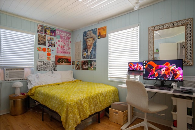 16535 Jamaica Inn Rd, Jamaica Beach, TX 77554 - bedroom featuring wood finished floors, cooling unit, an office area, and wood walls