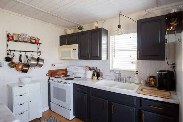 16535 Jamaica Inn Rd, Jamaica Beach, TX 77554 - kitchen featuring white appliances, a sink, light countertops, and light wood-style flooring