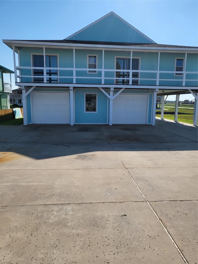 106 Driftwood Rd, Freeport, TX 77541 - view of front of house featuring a garage, driveway, and a balcony