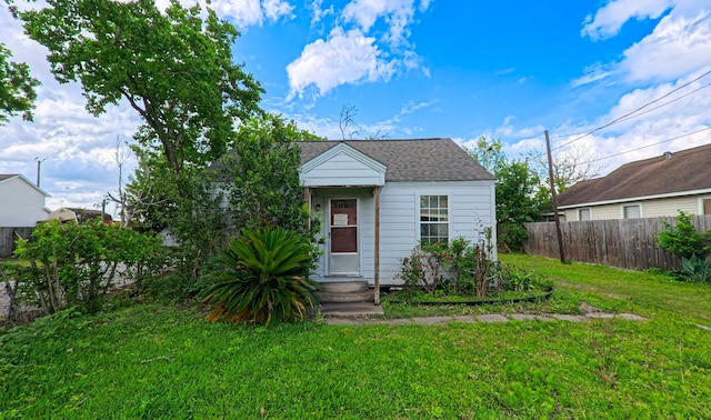 bungalow featuring a shingled roof