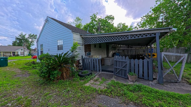back of property featuring a gate