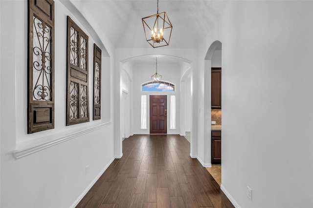 3031 Clover Trace Dr, Spring, TX 77386 - entryway featuring a chandelier, arched walkways, vaulted ceiling, dark wood-type flooring, and baseboards