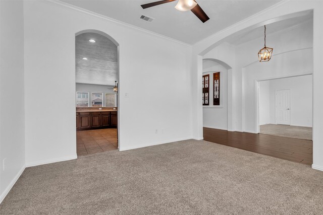 3031 Clover Trace Dr, Spring, TX 77386 - carpeted empty room featuring ceiling fan, crown molding, baseboards, arched walkways, and recessed lighting