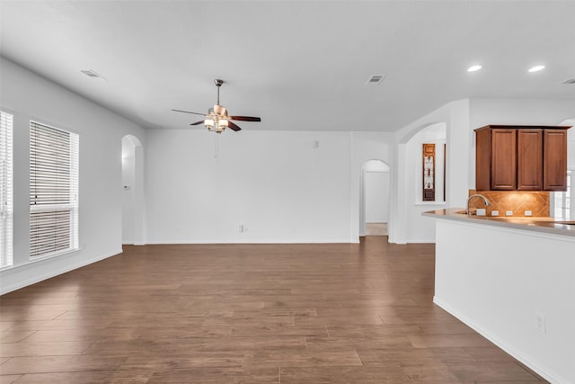 3031 Clover Trace Dr, Spring, TX 77386 - unfurnished living room featuring arched walkways, ceiling fan, recessed lighting, wood finished floors, and baseboards