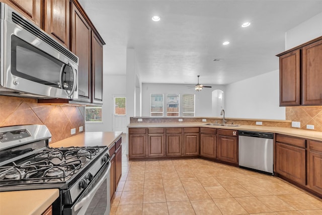 3031 Clover Trace Dr, Spring, TX 77386 - kitchen featuring stainless steel appliances, a sink, light countertops, recessed lighting, and backsplash