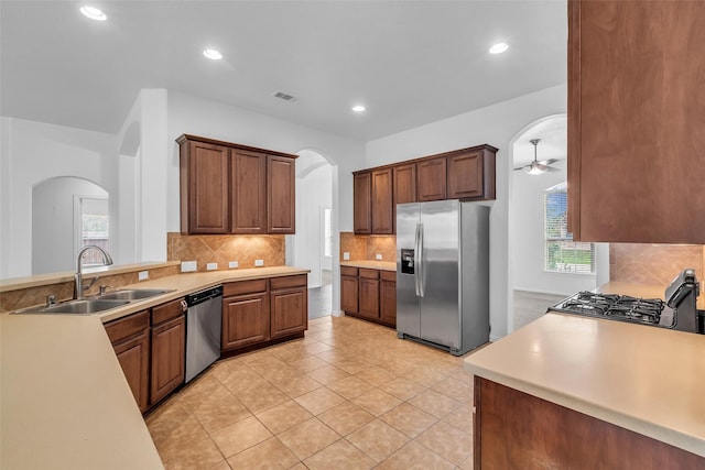 3031 Clover Trace Dr, Spring, TX 77386 - kitchen with appliances with stainless steel finishes, a sink, arched walkways, a ceiling fan, and light countertops