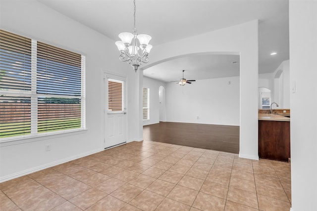 3031 Clover Trace Dr, Spring, TX 77386 - unfurnished room featuring arched walkways, ceiling fan, a chandelier, light tile patterned floors, and a sink