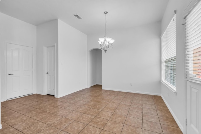 3031 Clover Trace Dr, Spring, TX 77386 - unfurnished room with arched walkways, light tile patterned floors, and a chandelier
