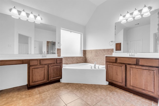 3031 Clover Trace Dr, Spring, TX 77386 - full bathroom with vaulted ceiling, a stall shower, a bath, tile patterned flooring, and two vanities