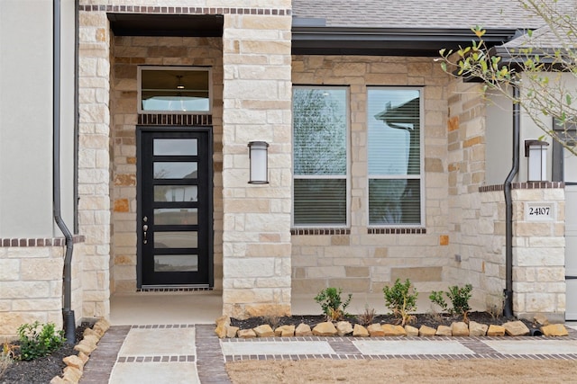 16163 Rustling Woods Rd, Conroe, TX 77302 - doorway to property featuring stone siding and roof with shingles