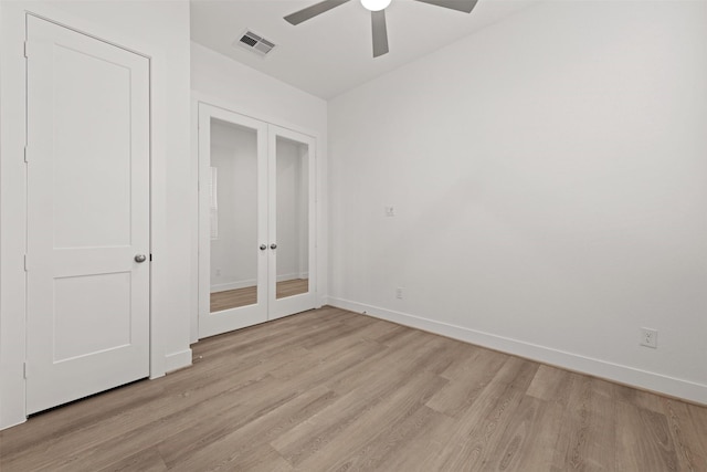 16163 Rustling Woods Rd, Conroe, TX 77302 - unfurnished bedroom featuring french doors, light wood-style floors, baseboards, and ceiling fan