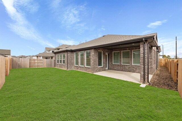 16163 Rustling Woods Rd, Conroe, TX 77302 - back of property with brick siding, a patio area, and a shingled roof