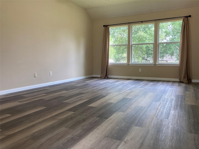 10479 Royal Tricia Dr, Conroe, TX 77303 - unfurnished room featuring dark wood-style floors, vaulted ceiling, and baseboards