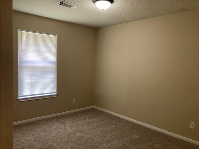 10479 Royal Tricia Dr, Conroe, TX 77303 - carpeted spare room with baseboards and a textured ceiling
