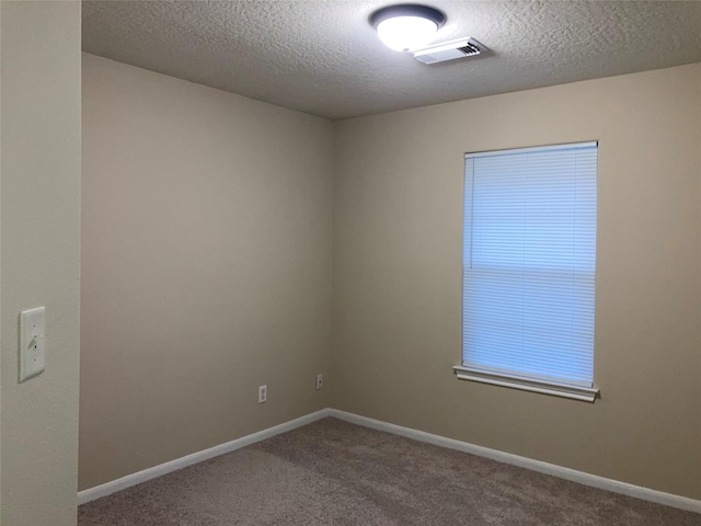 10479 Royal Tricia Dr, Conroe, TX 77303 - carpeted empty room with a textured ceiling and baseboards