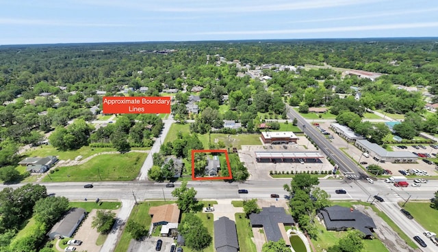 618 W Frank Ave, Lufkin, TX 75904 - aerial view of property and surrounding area with a heavily wooded area and property parcel outlined