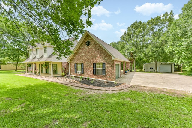57 Atascosita Trl, Dayton, TX 77535 - traditional-style house with brick siding, a front lawn, covered porch, concrete driveway, and an outdoor structure