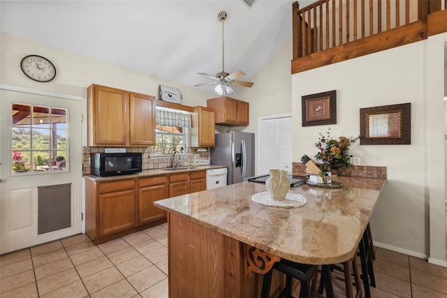 999 Salem Rd, Brenham, TX 77833 - kitchen with a sink, white dishwasher, a peninsula, black microwave, and light tile patterned flooring
