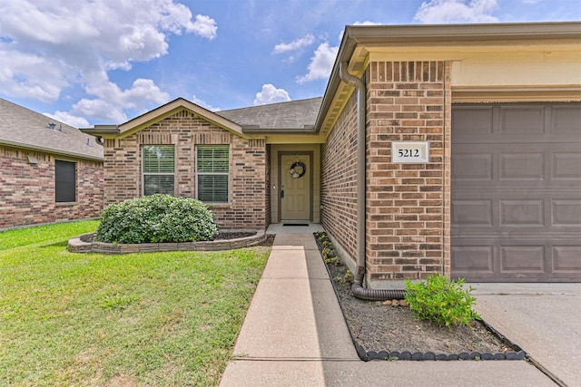 5212 Mcgrath Dr, Alvin, TX 77511 - entrance to property with brick siding, a garage, and a lawn