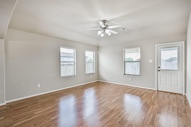 5212 Mcgrath Dr, Alvin, TX 77511 - unfurnished living room with a ceiling fan, healthy amount of natural light, light wood-style flooring, and baseboards