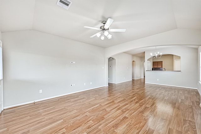 5212 Mcgrath Dr, Alvin, TX 77511 - unfurnished living room featuring lofted ceiling, arched walkways, light wood-type flooring, a ceiling fan, and baseboards