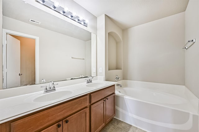 5212 Mcgrath Dr, Alvin, TX 77511 - bathroom featuring a garden tub, double vanity, and tile patterned flooring