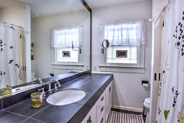 1119 E 7th 1/2 St, Houston, TX 77009 - full bath with toilet, vanity, a shower with shower curtain, and tile patterned floors