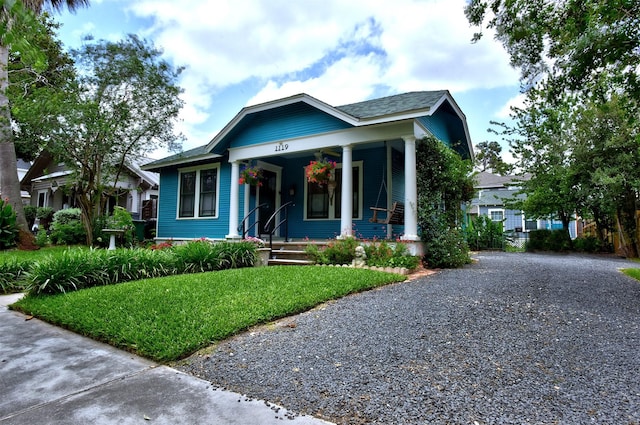 1119 E 7th 1/2 St, Houston, TX 77009 - bungalow-style home featuring covered porch, a front lawn, and driveway