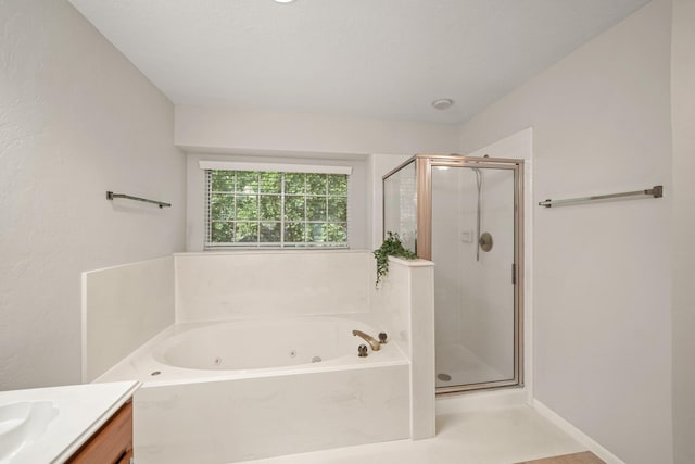 8602 Canyon Pine Dr, Spring, TX 77379 - bathroom featuring a stall shower, a tub with jets, vanity, and baseboards