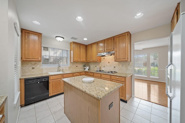 8602 Canyon Pine Dr, Spring, TX 77379 - kitchen with black dishwasher, a sink, under cabinet range hood, light tile patterned flooring, and recessed lighting