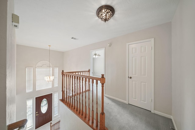 8602 Canyon Pine Dr, Spring, TX 77379 - hallway featuring an upstairs landing, a chandelier, carpet, and baseboards