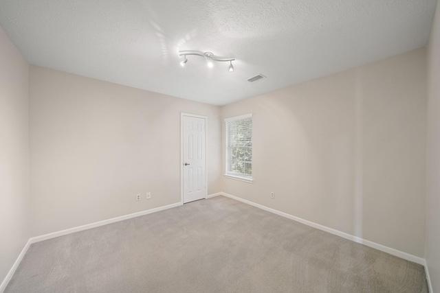8602 Canyon Pine Dr, Spring, TX 77379 - carpeted spare room with baseboards and a textured ceiling
