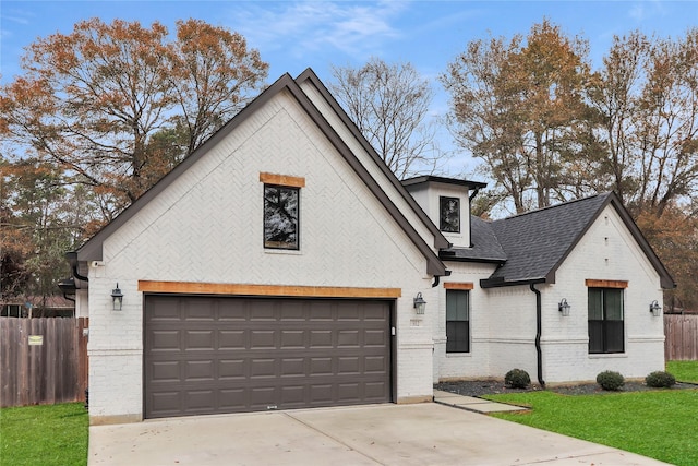 312 Tallow Dr, Conroe, TX 77385 - view of front facade featuring brick siding, concrete driveway, and roof with shingles
