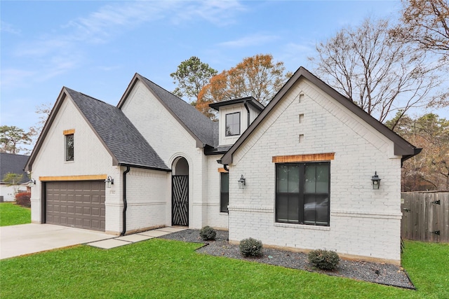 312 Tallow Dr, Conroe, TX 77385 - view of front of property featuring concrete driveway, a shingled roof, brick siding, and an attached garage