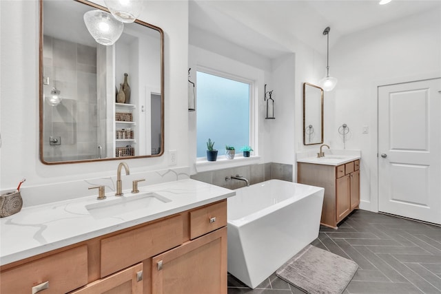 312 Tallow Dr, Conroe, TX 77385 - full bath with a freestanding bath, a shower stall, two vanities, and recessed lighting